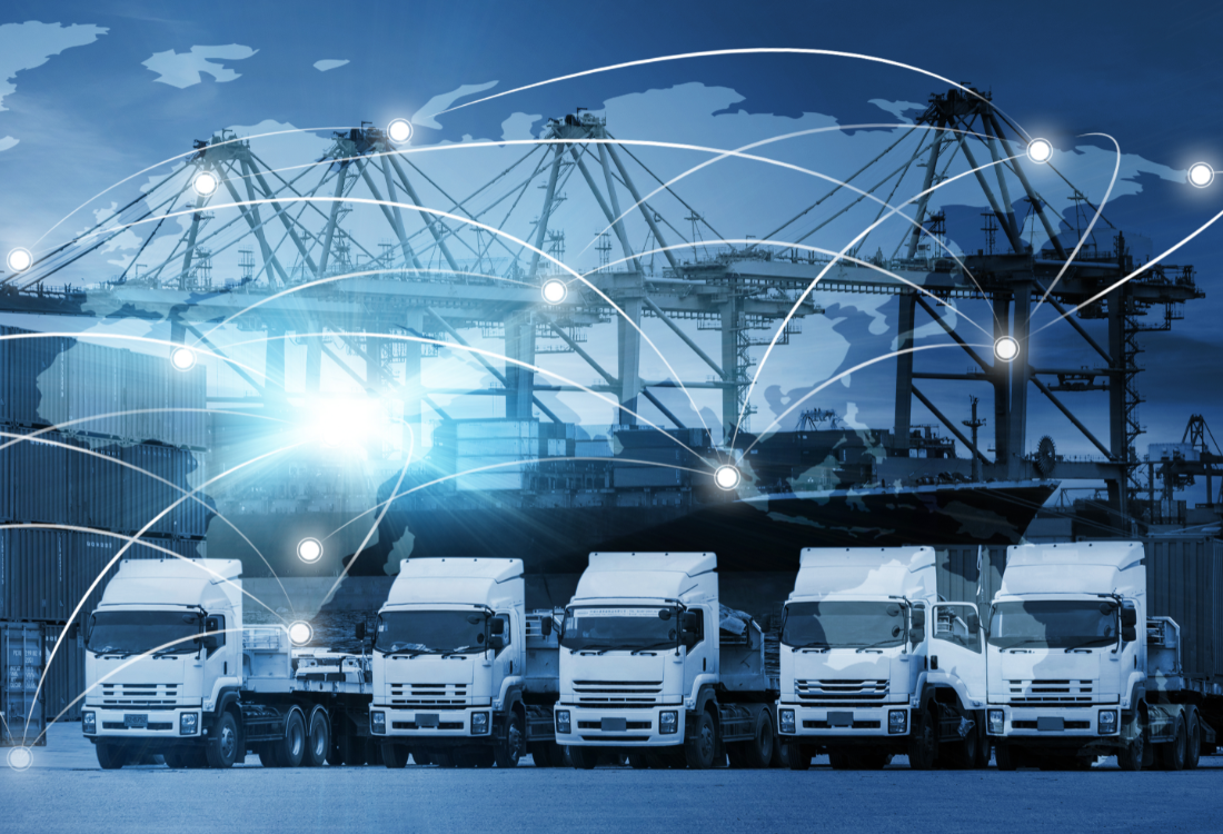 Cargo trucks lined up in front of shipping containers and cranes, with a world map and connected network lines overlay symbolising global logistics and containerised vehicle transport.
