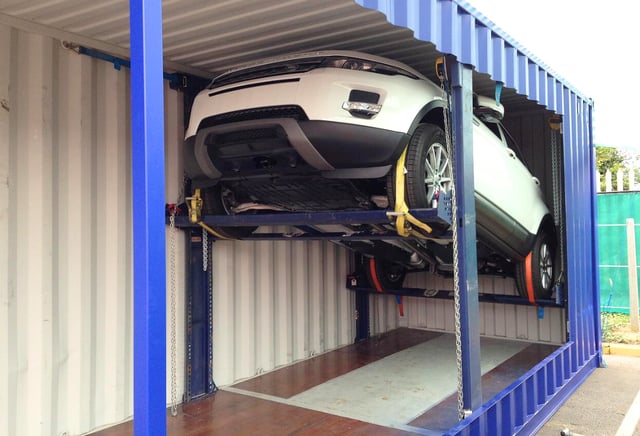 Vehicle being securely transported using a containerised solution. 