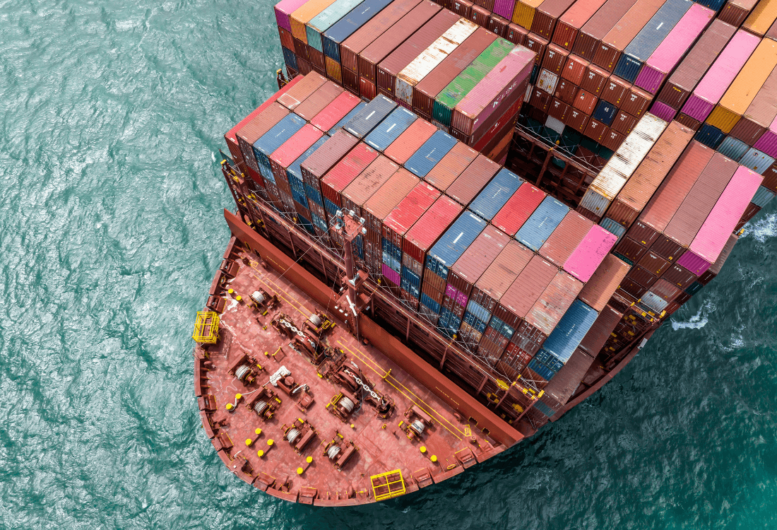 Shipping containers which are being transported on a boat.