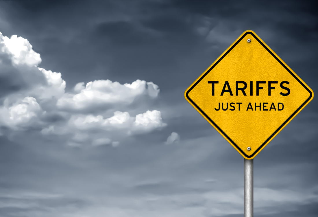 A yellow warning sign that states 'Tariffs just ahead' reflecting the uncertainty they are brining in the global automotive sector.