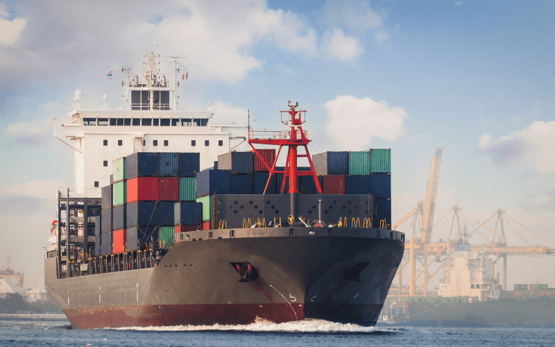Vehicles being transported on a ship highlighting the commitment to sustainability.