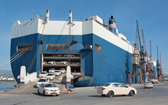 An image of a roro ship unloading cars representing the hazards of roro shipping