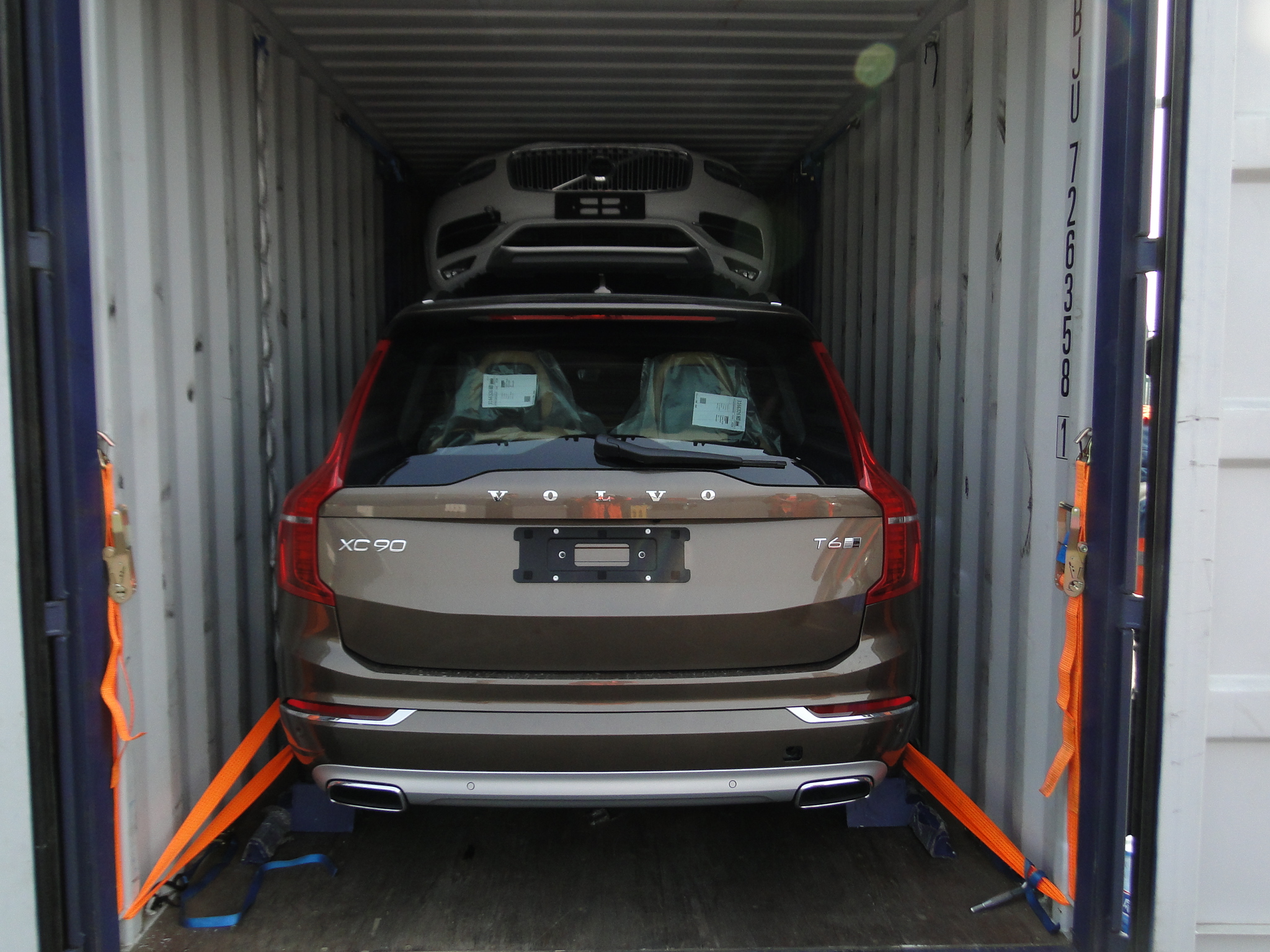 SUV secured inside a shipping container using a stacked vehicle transport system as part of multi-vehicle racking solutions for automotive shipping.