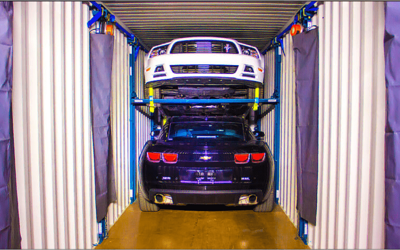 Trans-Rak Vehicle Racking System in place with 2 cars maximising space and cost efficiency in a shipping container with a multi car transport system.
