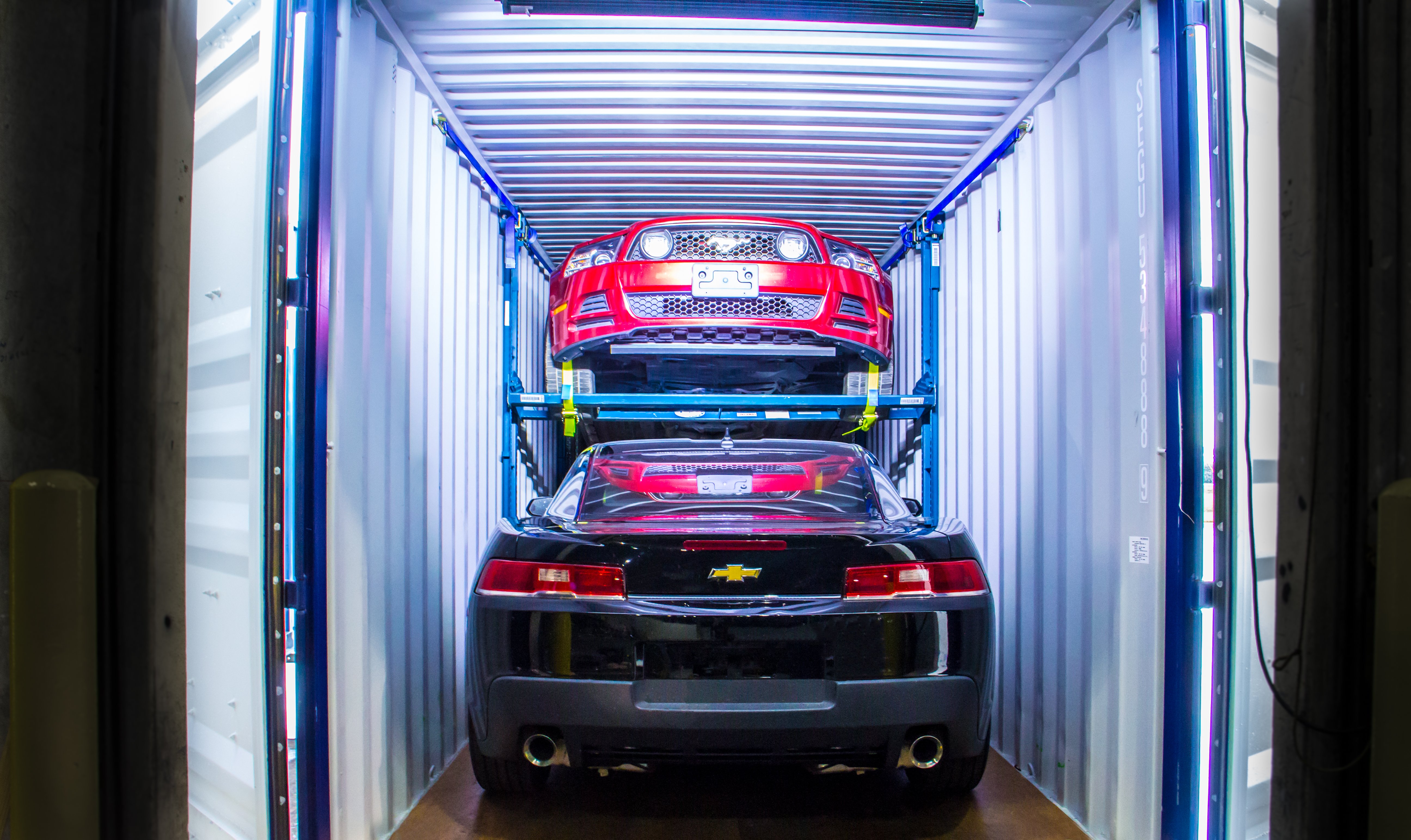 Containerised vehicle logistics with steel car racking for efficient vehicle loading.